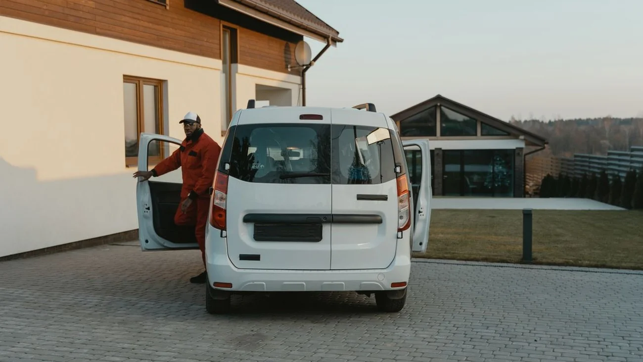 Professional plumber with tool bag next to a service van, ready for an emergency call